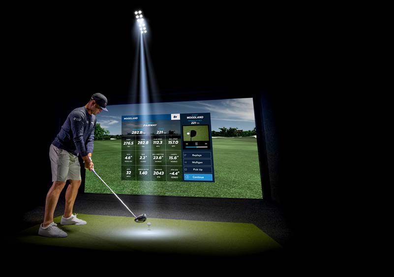 Golfer addressing the ball under the Full Swing ION3 overhead camera