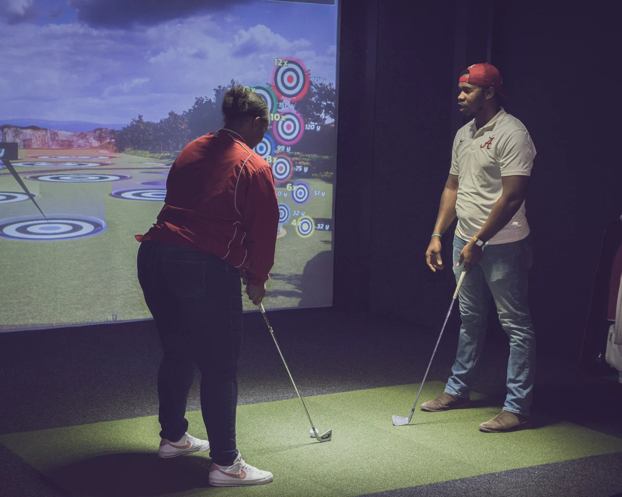 League players lining up a shot on the simulator