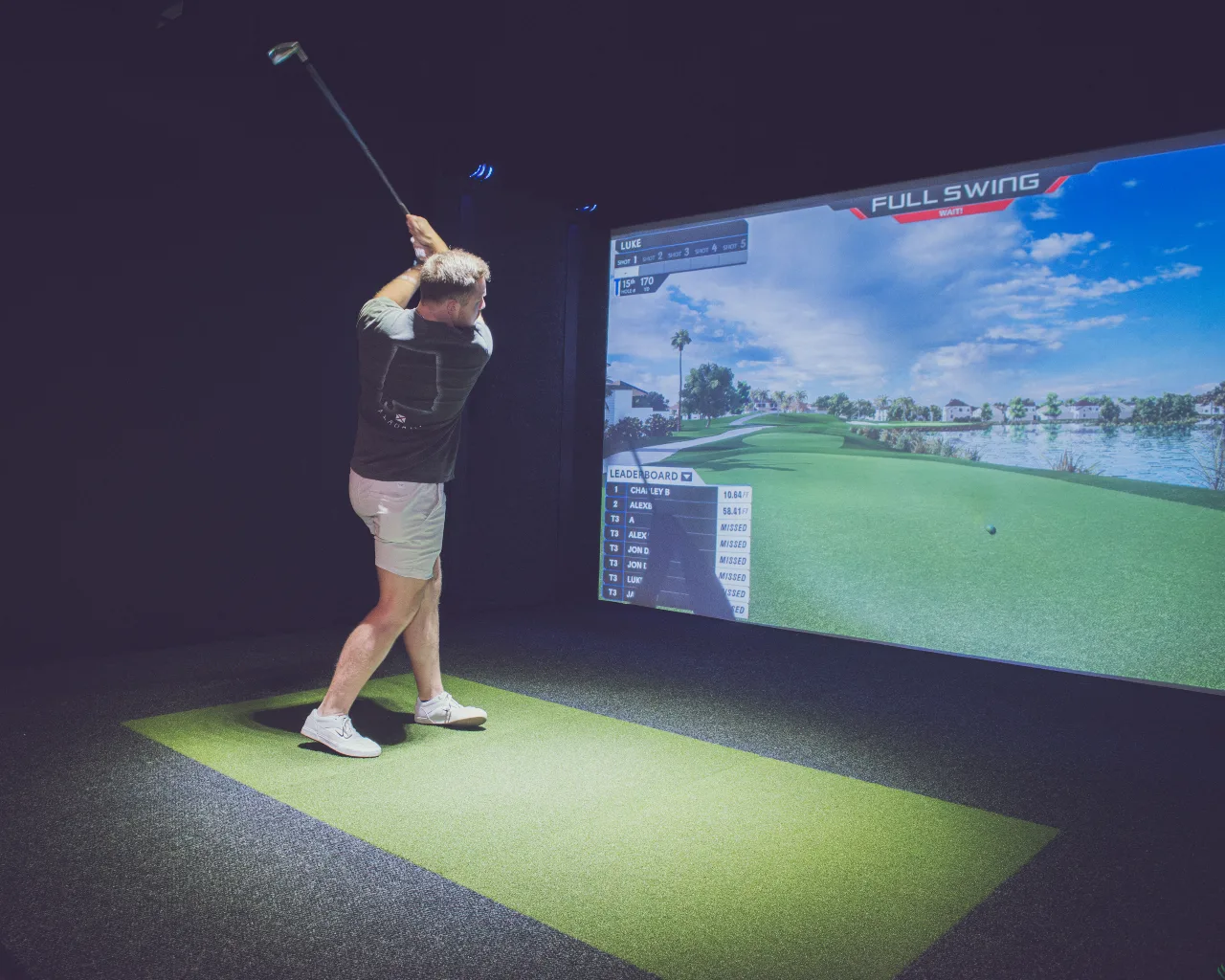 Member playing a round on a simulator at Swing Away Golf Club